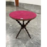 A Victorian walnut gypsy table with felt covered pine top. 21' diam.