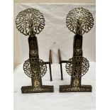 A pair of Arts and Crafts brass and cast iron andirons, 20th century, after the 17th century