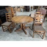 A set of four Ercol ladderback chairs with an extending dining table