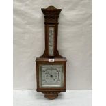 An early 20th century oak aneroid wall barometer. 27½'