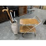A 1970s tea trolley and a metal stickstand with sticks