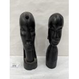 Two African carved ebony male and female heads. 10' high