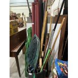 A quantity of fishing and rod tubes, nets, parasol etc.