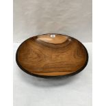 A carved treen bowl. 18½' diam.