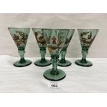 A set of five 19th century Bohemian green wine glasses, the funnel bowls painted in coloured enamels