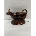 A Staffordshire cow creamer in mottled treacle glaze. 7' long