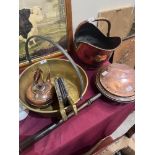 A brass preserving pan, copper coal scuttle, warming pan, copper kettle and brass fireside bellows