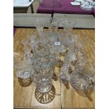 A collection of cut glass flower vases and jugs