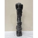 An African carved wood figure group. 21' high