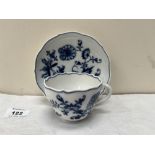 An 18th century blue and white foliate decorated teacup and saucer. Crossed swords marks in