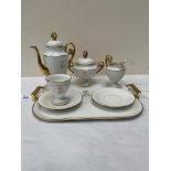 A Limoges cabaret set to comprise a coffee pot; sucrier; cream jug; one cup; two saucers and a tray.