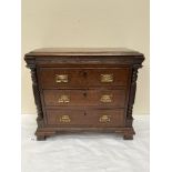 A Victorian oak miniature chest, the three long drawers flanked by wrythen turned pilasters,