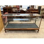 An oak glazed haberdasher's or display cabinet on cabriole legs. 70' wide