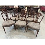 A late 19th century set of nine mahogany dining chairs in the manner of George Hepplewhite, the