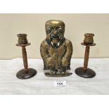 A Victorian brass figural nutcrack, 7¾' high together with a pair of casein candlesticks