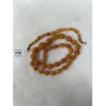 An amber necklace of thirty-three graduated beads, together with an amber bracelet of sixteen