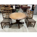 A set of four Ercol ladderback chairs with an extending dining table