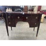 A 19th century mahogany bow-breakfronted sideboard, the crossbanded top over cellaret and three