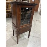 An early 20th century mahogany cabinet on stand enclosed by an astragal glazed door. 47' high.