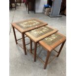 A 1970s Danish nest of three teak occasional tables with tiled tops by Mobelfabrikken Toften.