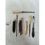 Penknives and buttonhooks etc, the larger knife marked George Wostenholm, Sheffield