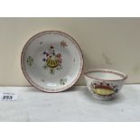 An 18th century English tea bowl and saucer painted in coloured enamels with shells and seaweed