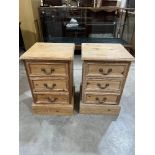 A pair of pine bedside chests of three drawers
