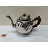 A continental silver teapot with facetted wrythen globular body and swan-neck spout. Handle