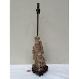 A 1920s soapstone lamp base carved as a figure of Guanyin. The figure and wood base 13½' high.