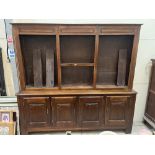 A 19th century joined walnut dresser, the raised upper part with six shelves, over base enclosed