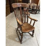 A Victorian ash lath-back rocking chair with shaped pierced splat