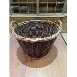 A wicker log basket. 21' diam.