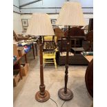 Two oak lamp standards with cream pleated shades