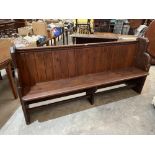 A stained pine church pew. 78' long