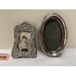 Two small silver photograph frames, the oval example 4¼' high (A.F.)