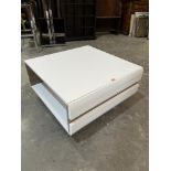 A modernist style white coffee table. 30' wide