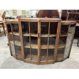 A 1930s oak display cabinet enclosed by four glazed doors. 60' wide