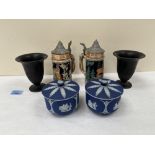 A pair of Wedgwood blue jasparware jars with covers, a pair of black basalt campana vases and two