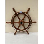 A wooden and metal mounted ships wheel. 22½' diam, together with a copper and brass model of a