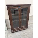 A mahogany bookcase enclosed by a pair of glazed doors. 35' wide