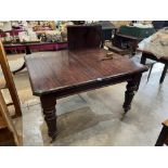A late Victorian mahogany dining table on turned legs. Extends to 71' with one extra leaf