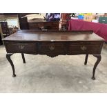 A 20th century oak dresser base in George III style, with three drawers on cabriole legs. 61' wide
