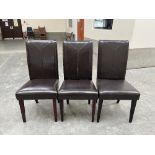 Three brown leather upholstered high backed chairs
