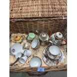 A wicker hamper of eggshell china and plate