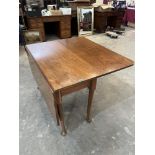 A dropleaf table on turned tapered legs with pad feet. 42' wide