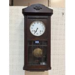 A 1930s oak cased wall clock, the two train movement striking and chiming on four tubular gongs. 30'