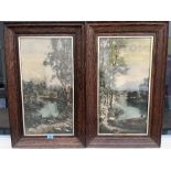 A pair of oak framed prints, castles in landscapes. 23' x 12'