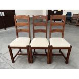 A set of three oak ladderback chairs