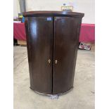 A George III mahogany bowfronted hanging corner cupboard. 37½' high