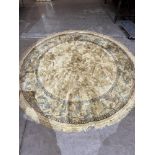 A gold ground circular rug. 78' diam.